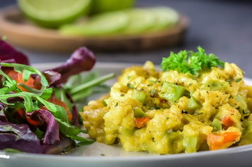 Healthy vegan cuisine - scrambled eggs with avocado - close up