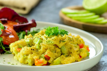 Healthy vegan cuisine - scrambled eggs with avocado - close up