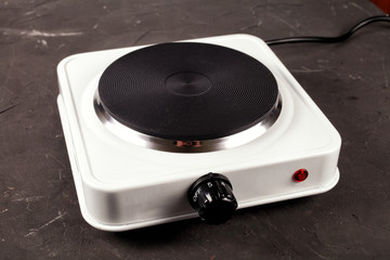 single-electric stove on a dark kitchen table, selective focus