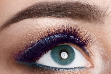 Young woman with color eyelashes and beautiful makeup, closeup