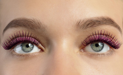 Young woman with color eyelashes and beautiful makeup, closeup
