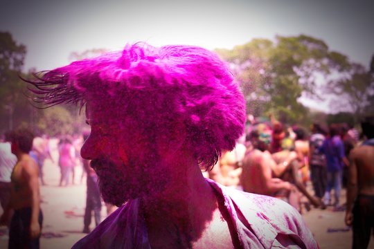 Man Tossing Hair With Powder Paint During Holi