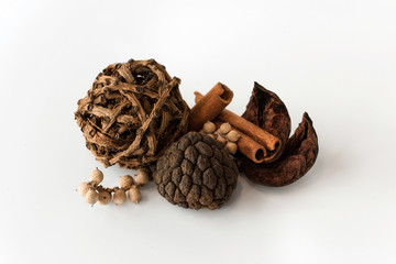 Nature object (canela, ball of larch branch, cinnamon stick, lily petals) for decoration isolated on a white background.