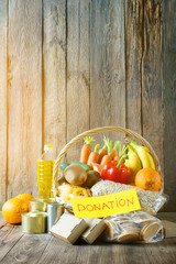 Food donation basket with different products and vegetables in a basket with text Donation....
