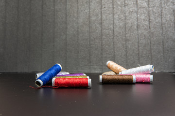 Colorful yarn fall together on a black background