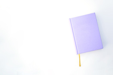 Purple notebook or book on the bright background with the yellow ribbon mockup