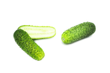 Fresh organic cucumber and two halves of a cucumber isolated on white background
