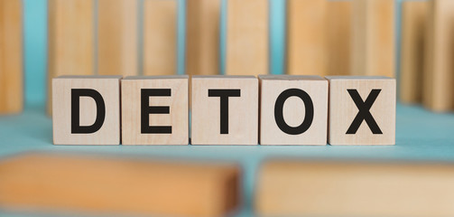 Detox word written on wood cubes with block background. Medical concept