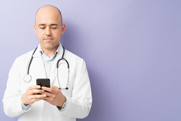 Physician using smartphone in a studio