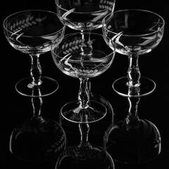 Champaign glasses Gatsby - style on black backdrop with reflections 
