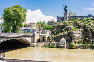 Old Metekhi district. Statue of Vakhtang Gorgasaliin and the rock above the river Kura temple Abo...