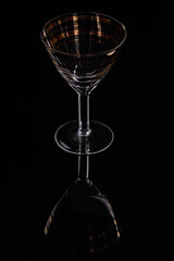 One yellow glass on the black backdrop with nice reflection