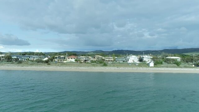 Australias Great Ocean Road, aerial view of a nearby sea road reveals the house, Melbourne, Australia