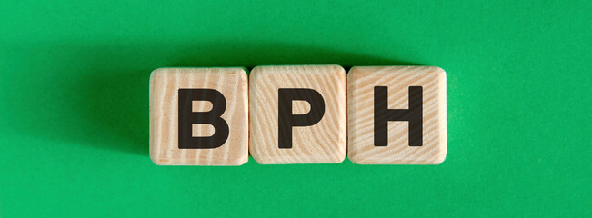 BPH - text on wooden cubes with green background