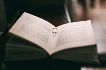Fototapeta premium Wedding ring and book
