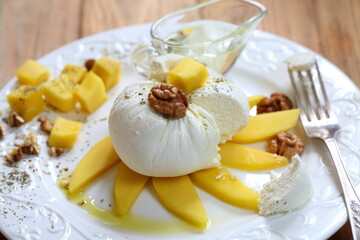 Soft white cheese with mango, walnut and honey
