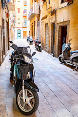 Motorbikes and Motor Scooters/ Vespa parked along backstreet in European city. Traditional mode of transportation used by people in Europe.