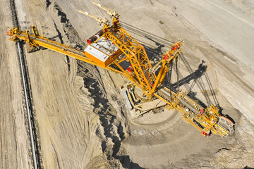 Top view of a bucket wheel excavator mining coal in an open pit mine. 