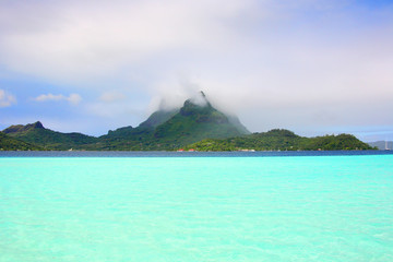 Turquoise Bora Bora lagoon with volcanic mountains