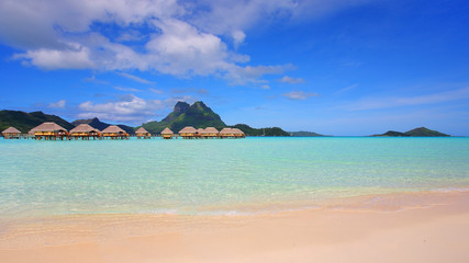 Bora Bora lagoon with mountain, beach and overwater huts