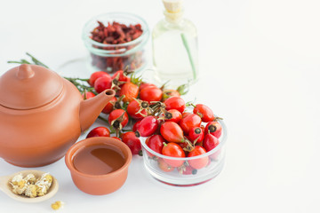 Dog rose, bunch branch Rosehips, types Rosa canina hips and herbal tea - Medicinal plants herbs composition on white