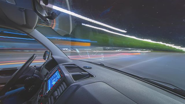 The man drives a car on the night city road with a virtual gps. hyperlapse