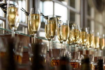 Glasses of cold champagne on a festive cocktail table at a wedding 