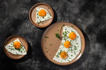 Fried eggs on a ceramic plate with herbs