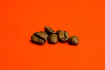 Coffee beans on a red uneven background