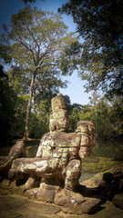 Fototapeta na wymiar Statue of guardians in the bridge in Angkor Wat, cambodia, sunny day