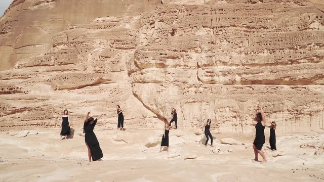 Group of women practice ecstatic dance in canyon