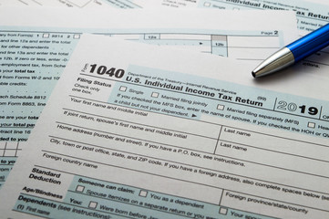 Obraz premium Tax form business financial concept: close up view of individual income tax return form 2019 and blue metal ballpoint pen