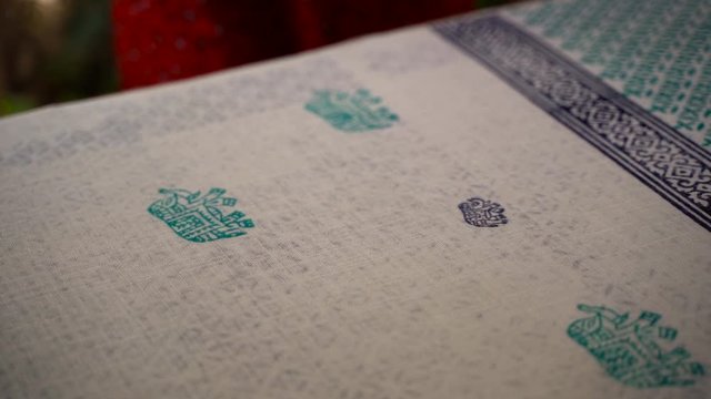 Block printing fashion in India, Close up of young woman block brinting in Japiur, Rajasthan, India. Traditional hand made wood block printing method in textile printing factory.