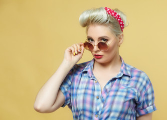 beautiful blonde posing on a yellow background