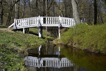 Bridge reflection in the river in the park of  Hutten-Czapsky Manor.  Stankovo, Belarus.