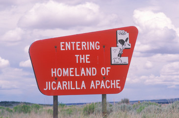 Bright red sign Entering the Homeland of Jicarilla Apache in NM