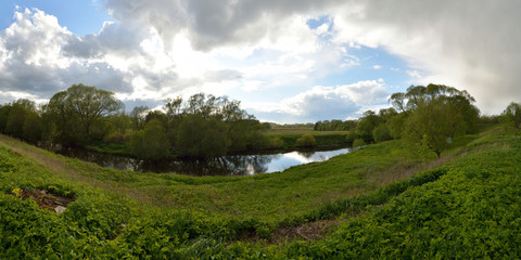 Spring fishing on the forest river, panorama.