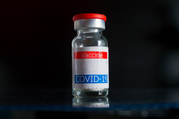 coronavirus vaccine vial displayed on glass shelf