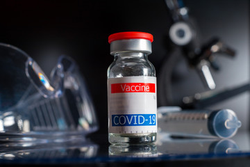 coronavirus vaccine container displayed on glass shelf in laboratory