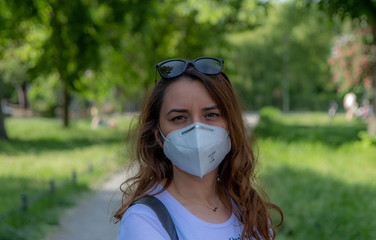 New lifestyle after coronavirus pandemic. Women wearing a mask at a park during Covid19 pandemic. 
