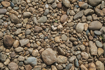 Round stones pebbles, top view, background