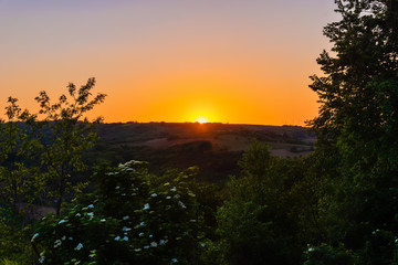 Sunset in Vojvodina in Serbia, near the mountain of Fruska Gora. Sunset over mountains