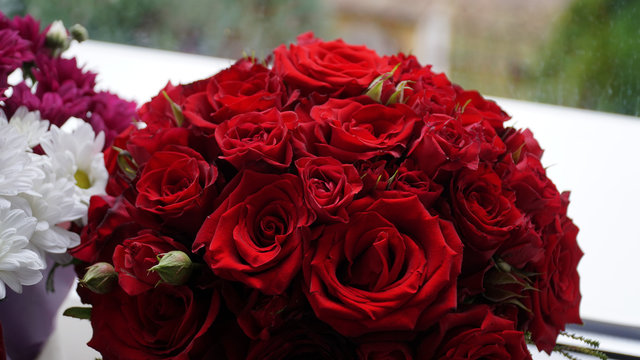 Red wedding bouquet on the window
