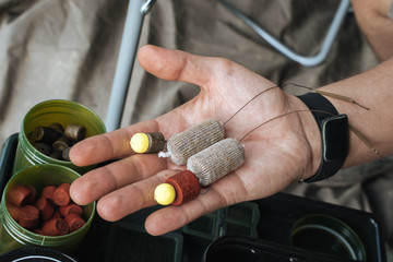 Bait and accessories for fishing in the palm of a man's hand © Tsakno