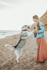 dog with girl running on the sea shore husky love
