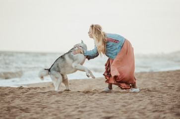 dog with girl running on the sea shore
