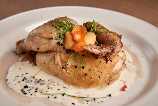 Baked, tasty juicy, quail with spices herbs and  sauce, beautifully served
