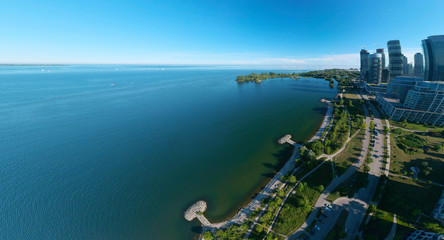 Artistic creative view of Humber Bay Shores Park city view and green space with skyline cityscape, azure lake Ontario. Skyscrapers over The Queensway on sunset at summer, Etobicoke, Ontario, Canada