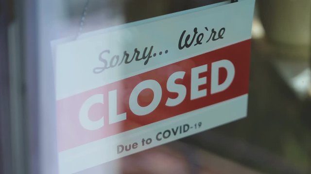 Closed sign hang on the glass in pandemic time in 4K Slow motion 60fps