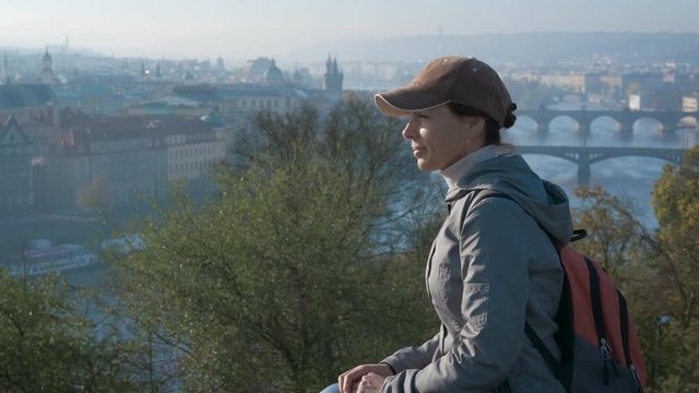 Panorama of europe city in the morning. Woman tourist enjoys the view of Prague bridges in the autumn morning.
